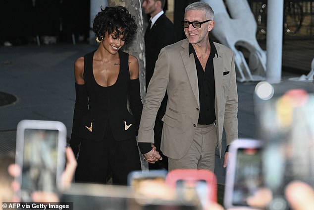 French actor Vincent Cassel (R) arrives with his partner, Brazilian girlfriend Narah Baptista