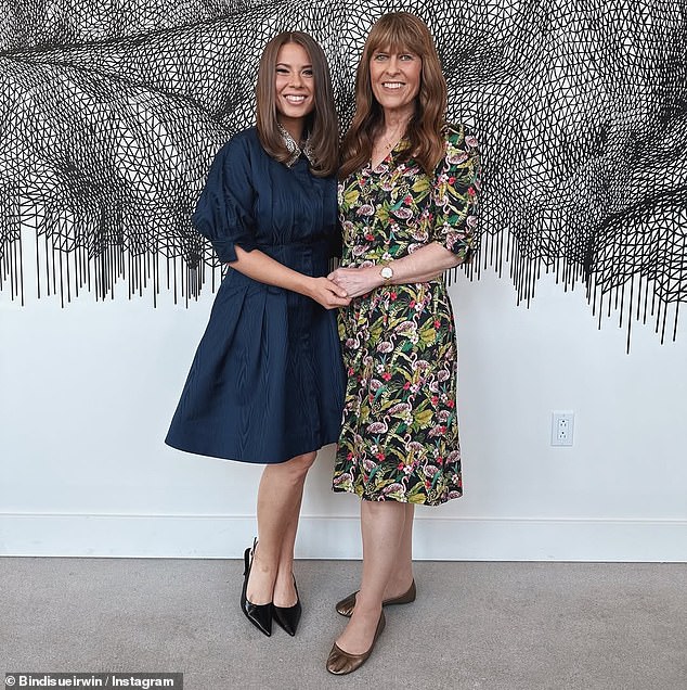 In a post shared to Instagram, the 27-year-old dazzled in a navy blue frock with a diamante-emblazoned collar. (Pictured: Bindi Irwin and Terri Irwin)