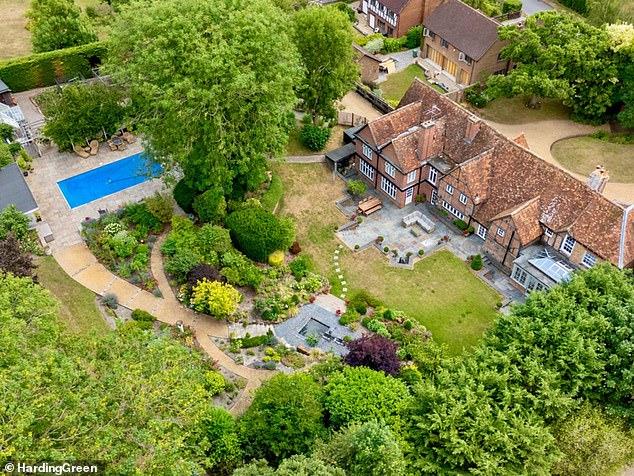 The Grade II listed property, named Claridges, boasts two acres of 'manicured gardens' and a heated outdoor swimming pool