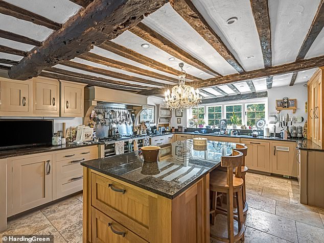 The home's kitchen is furnished with wooden fittings and polished worktops