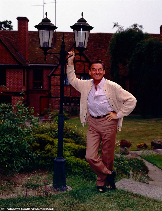 Bob Monkhouse stands outside his 17th century manor house in Eggington, which has now gone on sale for £3.15m