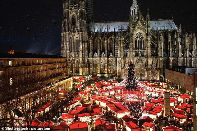 Airfares to Cologne, a city set along the Rhine River in western Germany, have seen a drastic drop in the past year, according to Skyscanner, with some one-way flights from London airports starting at just £14 (Pictured: Cologne Cathedral Christmas Market)