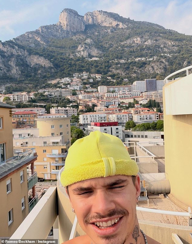 Romeo Beckham showed off his new diamond tooth gem as he posed for shirtless Instagram snaps on a rooftop in Monaco on Monday