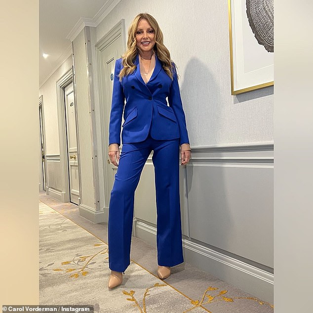 Carol Vorderman slipped her gym-honed physique into a cobalt blue suit as she enjoyed a day at the races following her recent health woes.