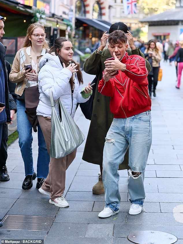 The star stopped to pose for some selfies with fans waiting to see him outside the radio studios