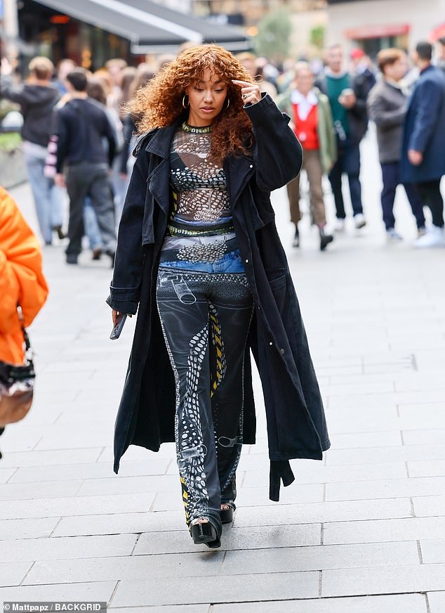 The former Little Mix star flashed her bra in an eye-catching pair of sheer printed trousers and a matching top