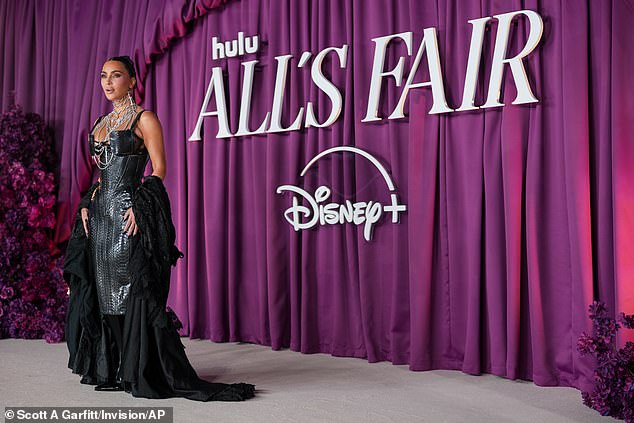 The star's snakeskin look was combined with a dramatic matching satin coat, and she completed her look with a vast array of silver jewellery