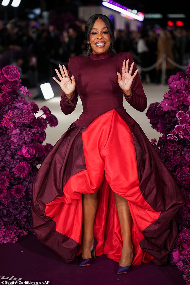 Niecy was in high spirits as she arrived for the premiere in a wine-coloured dress with a voluminous frilled skirt