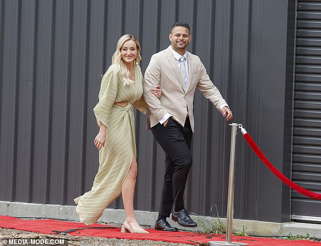 Britt looked glamorous for auction day in a long sparkly gold dress as she walked into her property ahead of the bidding