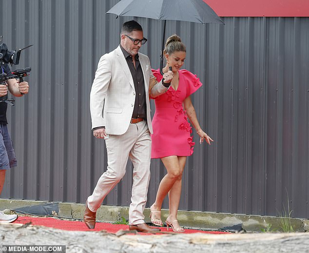 Sonny and Alicia looked stylish as they shielded themselves from the rain