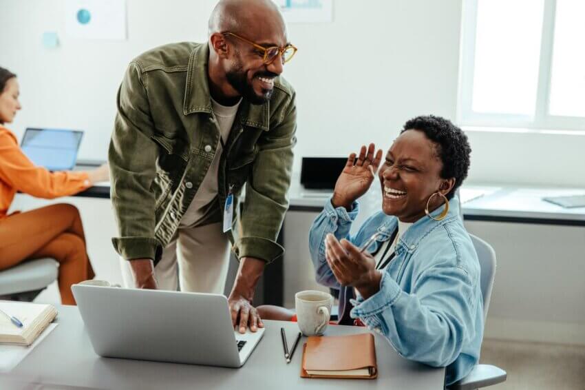 Two people laughing at work
