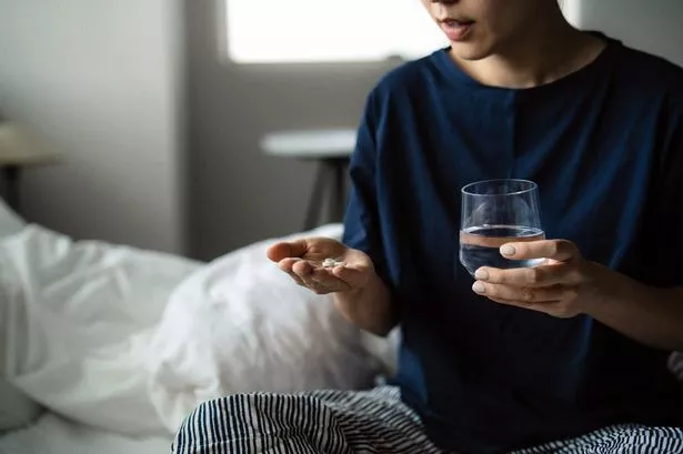 A woman taking common painkillers