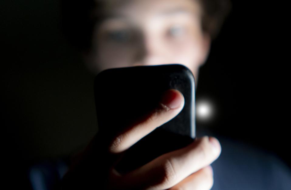 Smartphone user in the dark.