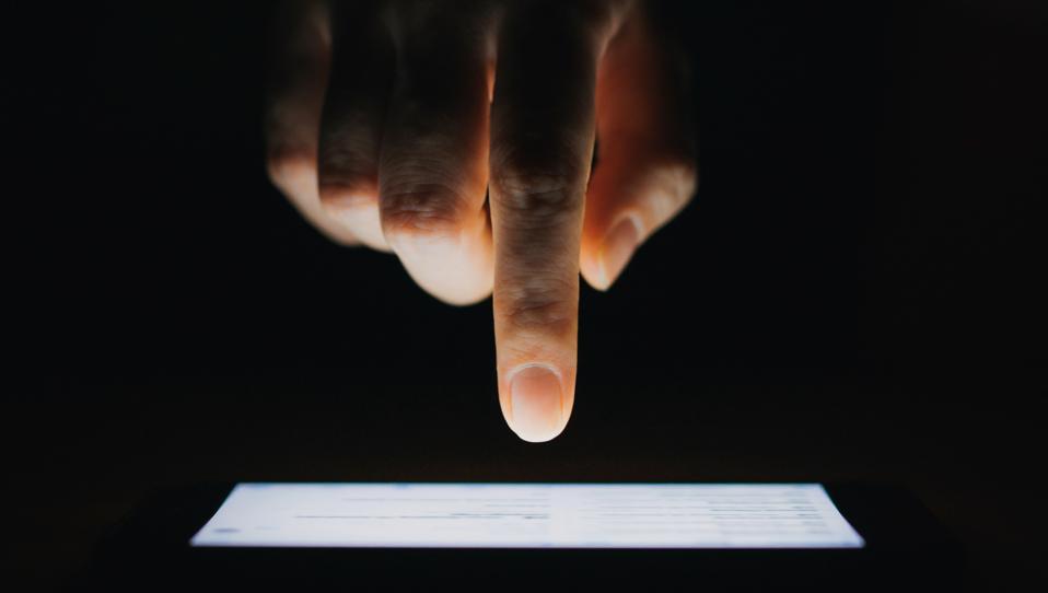 Close up of woman's hand using phone.
