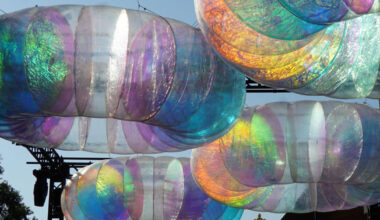 floating oculus installation shimmers in shifting chromatic light