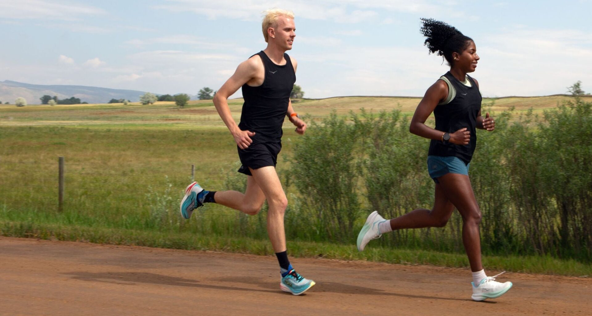 a man and woman run on a dirt road