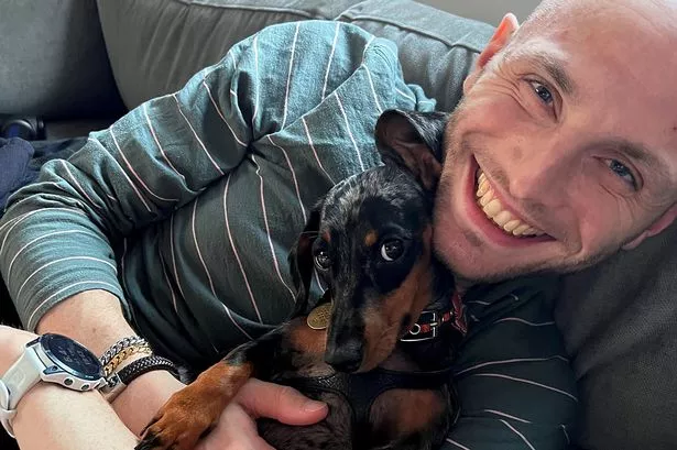 Dan Godley, 30, pictured with his sausage dog Lucy, is now cancer-free