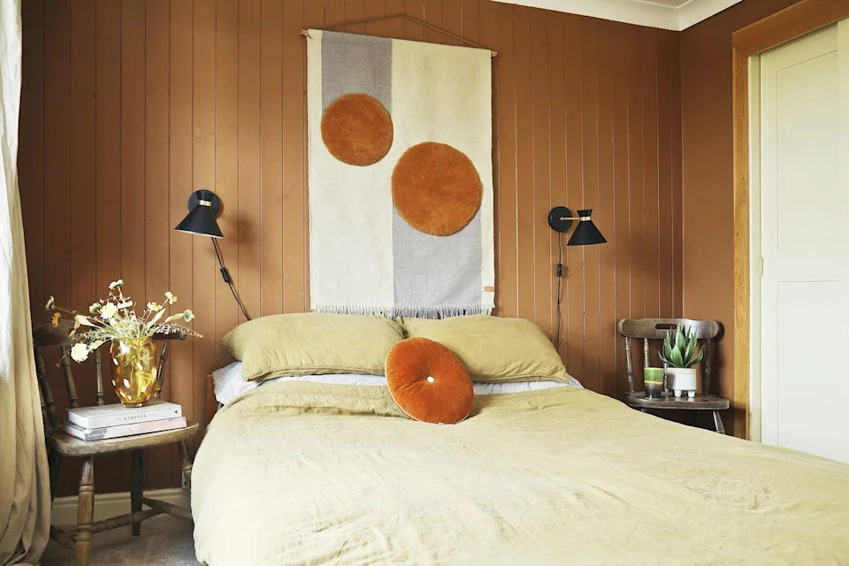 bedroom with panelled wall and wall hanging