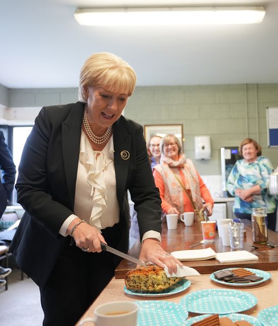 Fine Gael presidential candidate Heather Humphreys cuts a cake at half-time during a visit to a game at Upperchurch Drombane GAA in Tipperary while on the campaign trail (Niall Carson/PA)