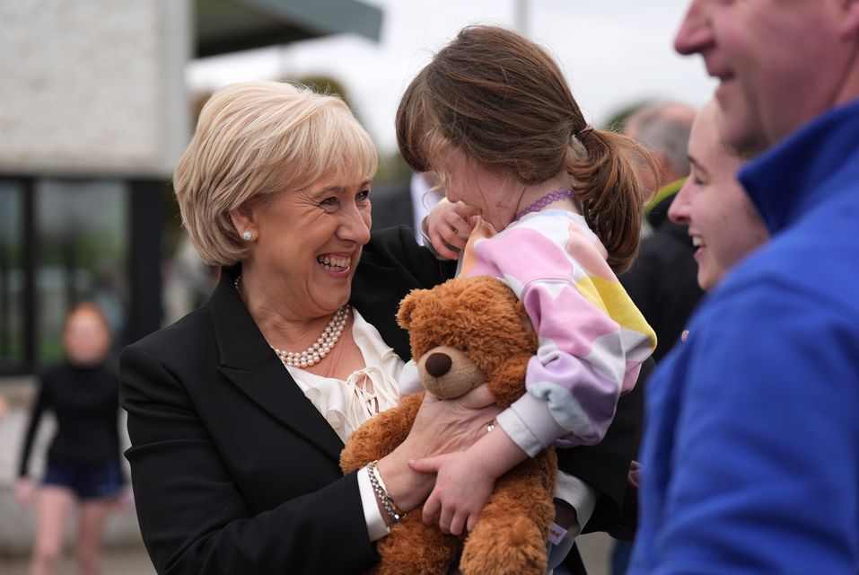 Fine Gael presidential candidate Heather Humphreys meets Ruth Ryan, aged four, holding her teddy Bruno, during a visit to Upperchurch Drombane GAA in Tipperary (Niall Carson/PA)
