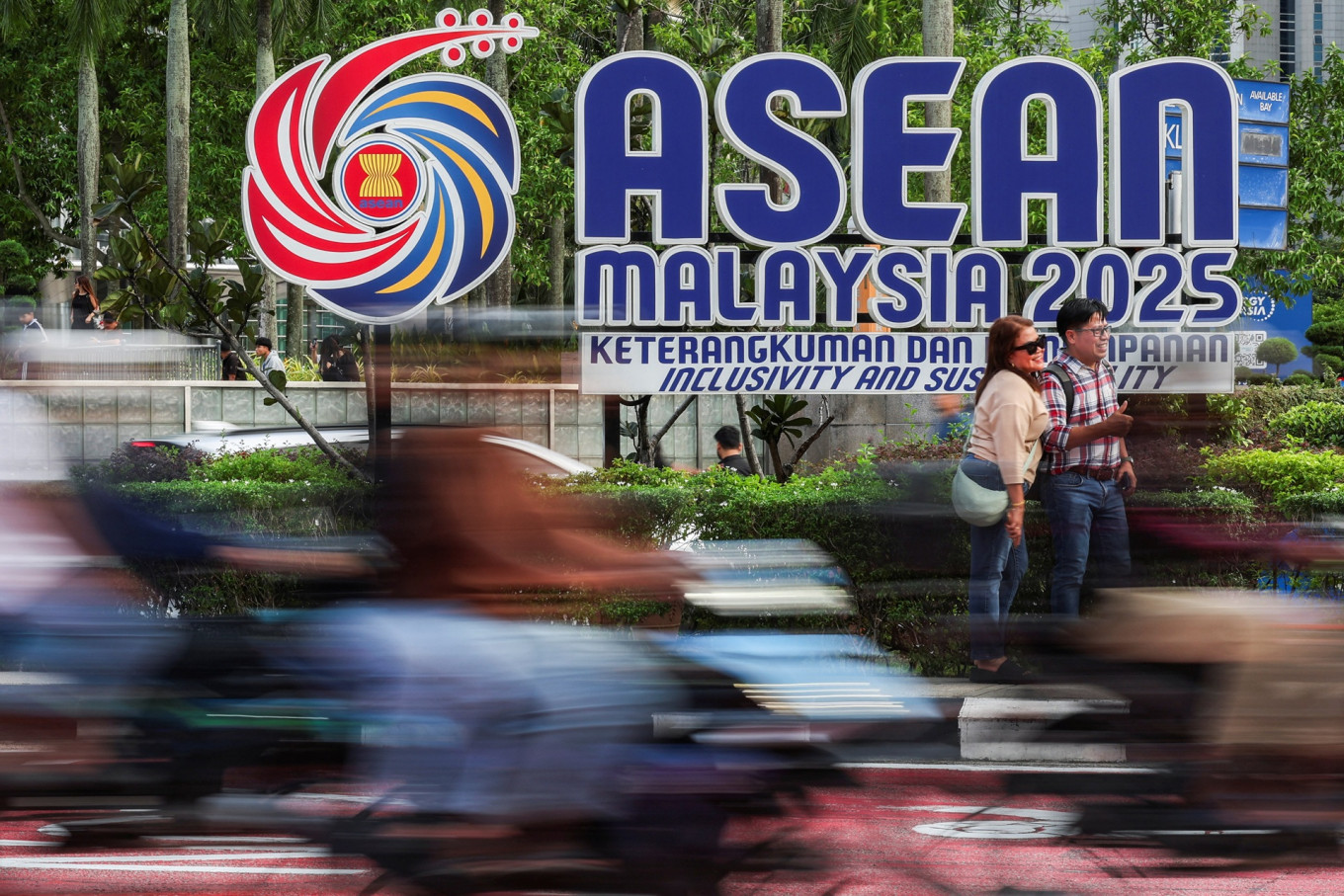 People take photos next to the ASEAN logo ahead of the 47th ASEAN Summit in Kuala Lumpur, Malaysia, on Oct. 24, 2025.