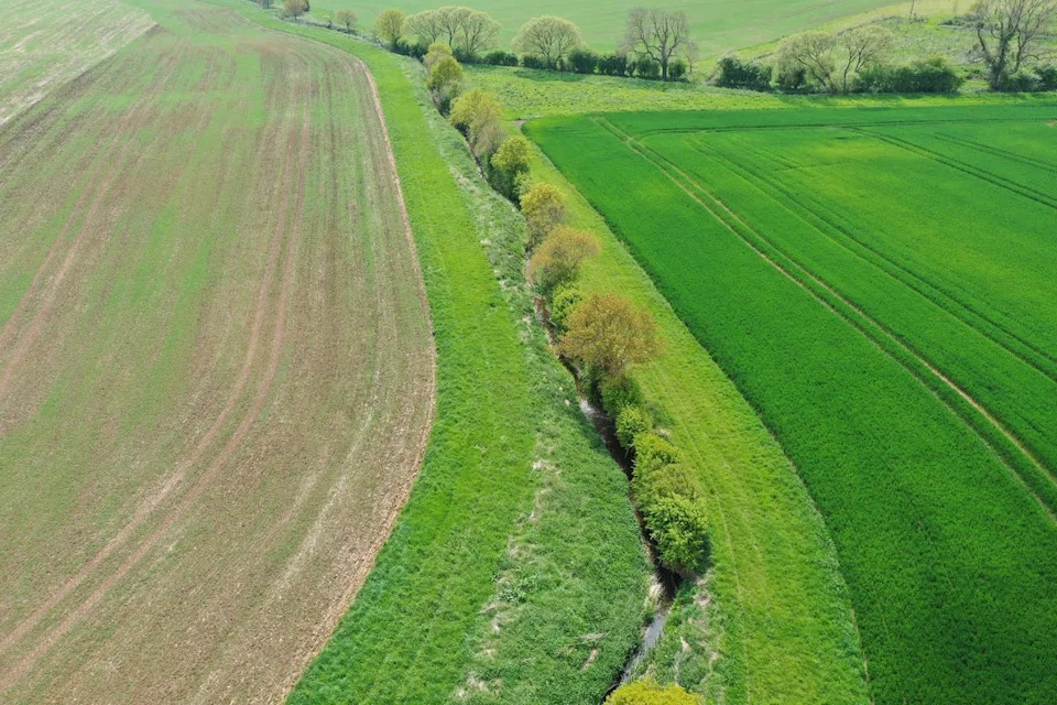 A river running between two fields at the Boothby Wildland project in Lincolnshire (Nattergal/PA Wire)