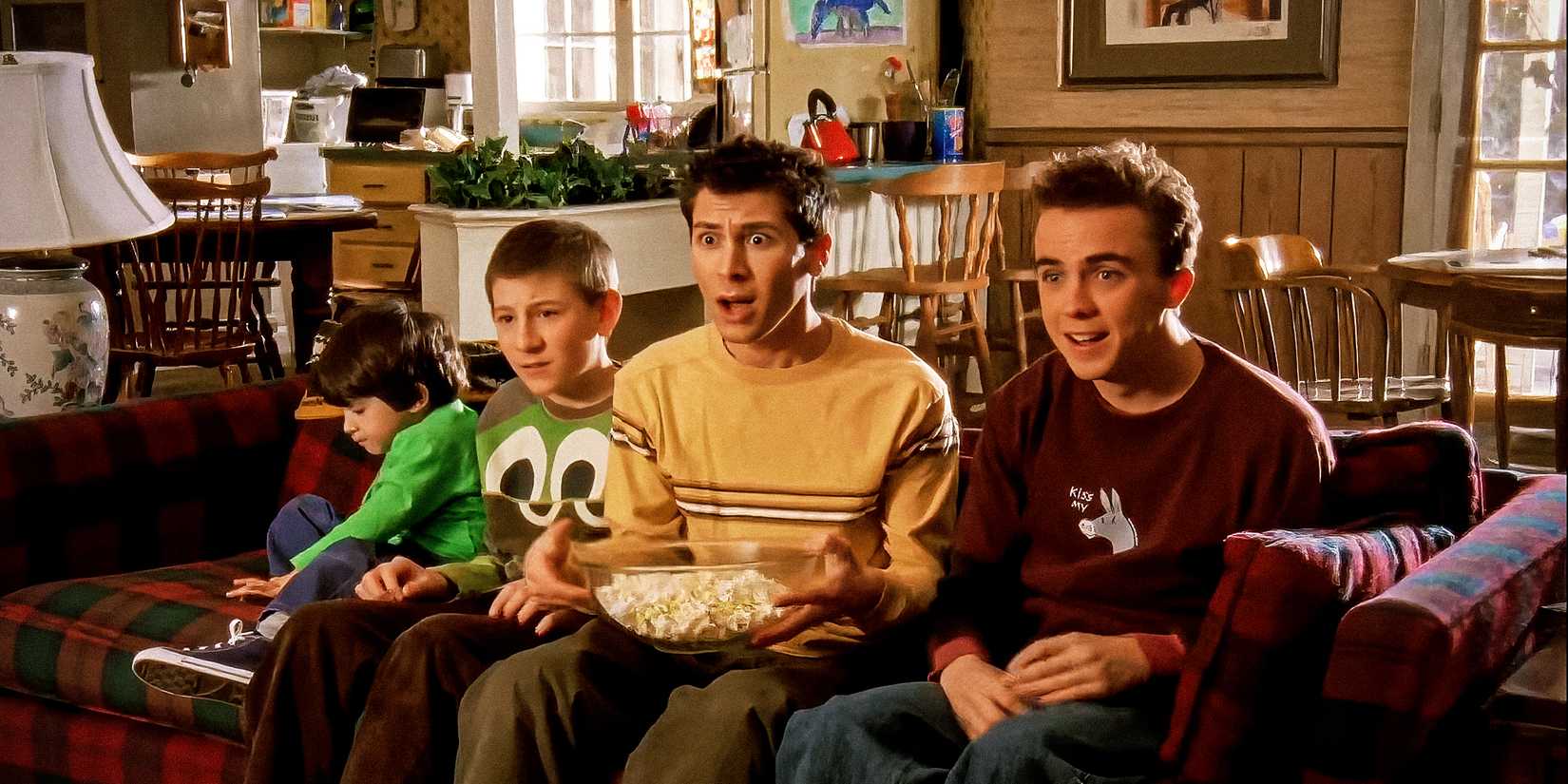 Malcolm in the MIddle family looking shocked on a couch