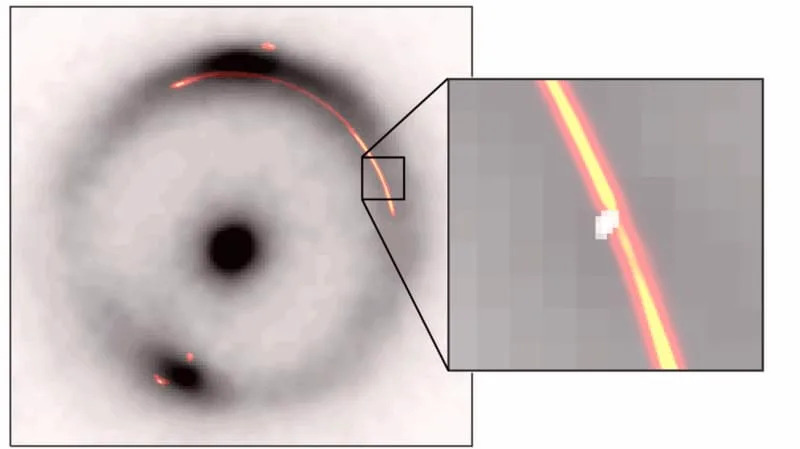 The black ring and central dot show infrared image of a distant galaxy distorted by a gravitation lens. Orange/reg shows radio waves from the same object. The inset shows a pinch caused by another, much smaller, dark gravitational lens (white blob). (CREDIT: Devon Powell, Max Planck Institute for Astrophysics)