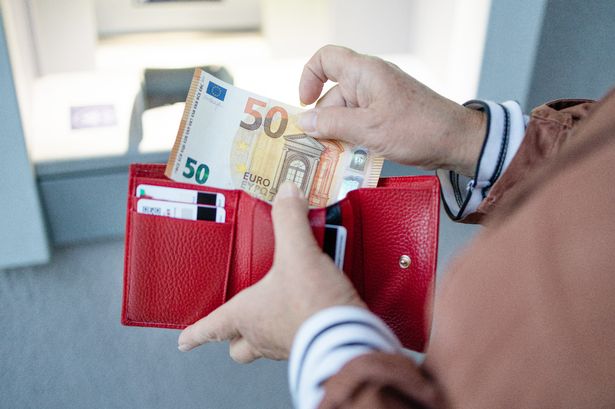 A woman taking euro notes out of her purse