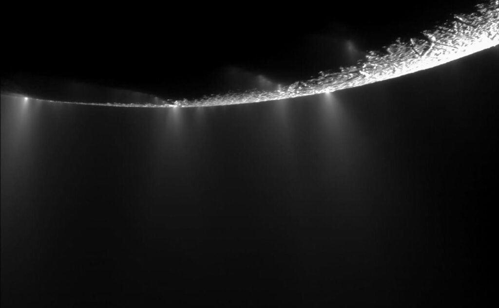 Image of the surface of Enceladus showing its jets erupting into space