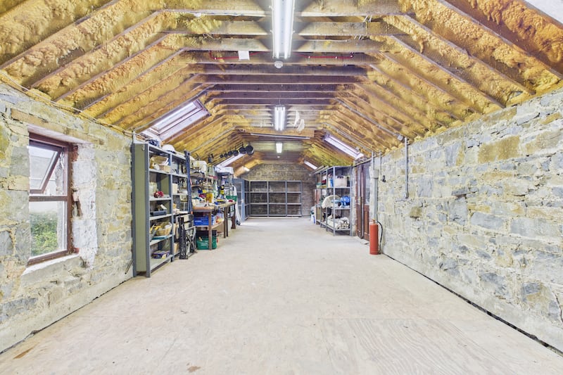 Interior of the cut-stone outbuilding, once used as a grain store for the local mill