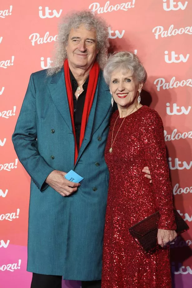 Photo of Queen guitarist Sir Brian May and his wife actress Anita Dobson posing for photographs at an ITV gala event in London