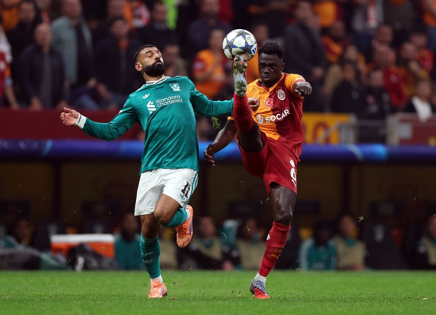 Liverpool’s Mohamed Salah loses out in a battle for possession with Davinson Sanchez of Galatasaray during last night’s Champions League clash. Photo: Getty