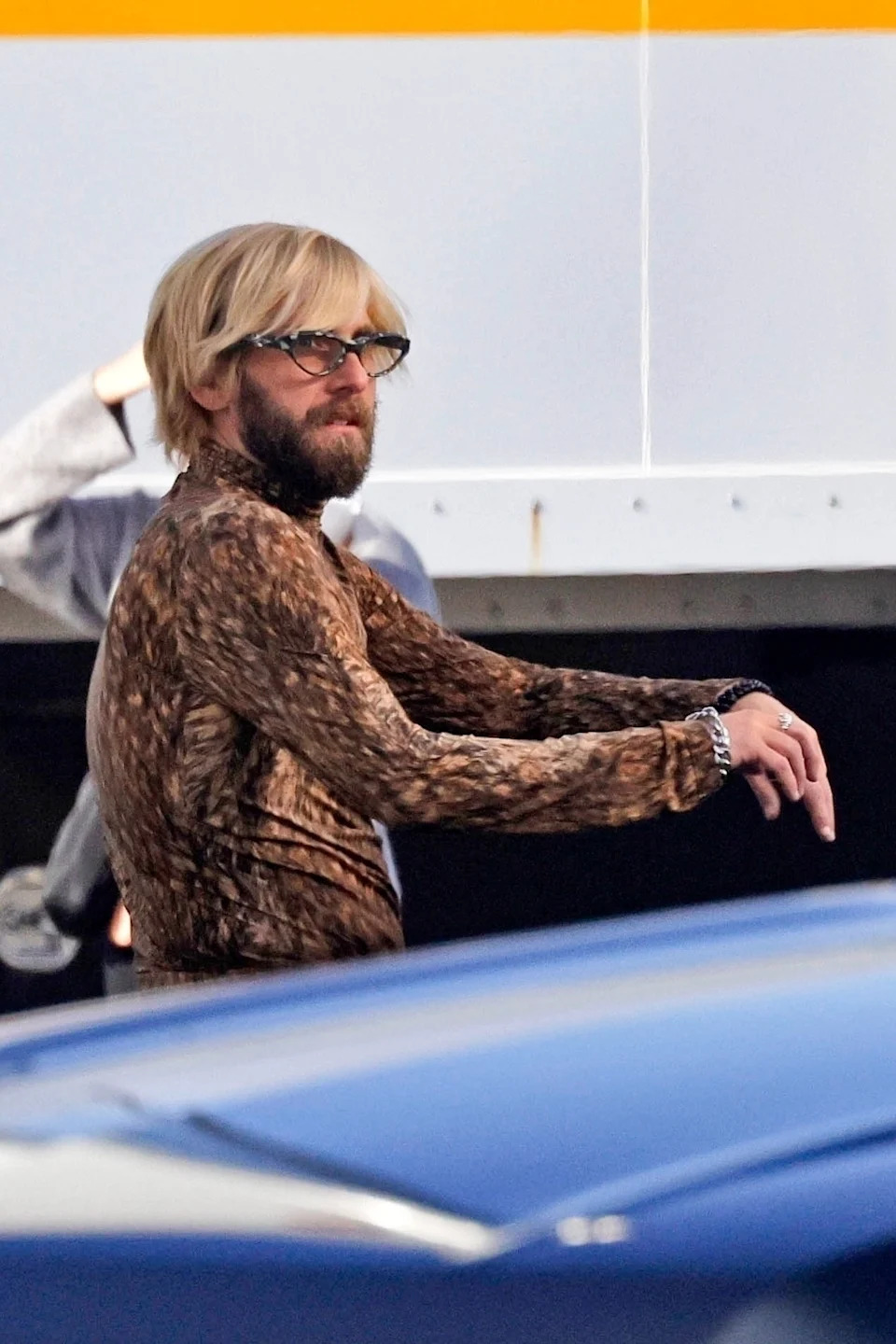 Jonah Hill standing outdoors while filming a movie