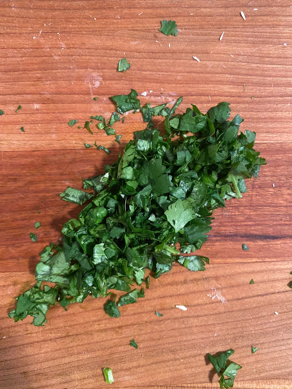 Chopped parsley on a wooden cutting board