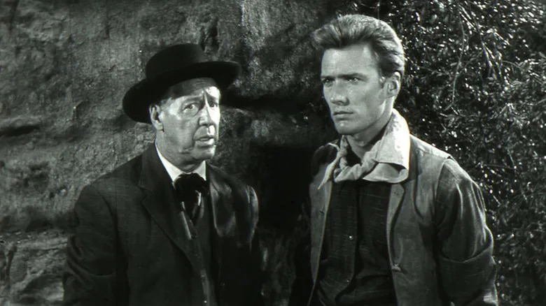 Stanfield (Irving Bacon) stands next to a stoic Keith Williams (Clint Eastwood) in Ambush at Cimarron Pass