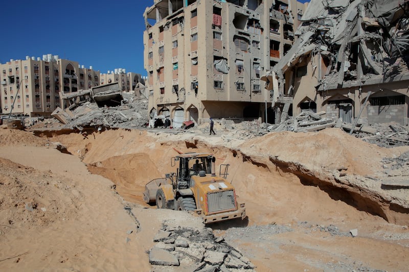 Palestinians use an excavator, reportedly searching for bodies in Khan Younis in the southern Gaza Strip. Photograph: ABDOLRAHMAN RASHAD/Middle East Images/AFP via Getty Images              