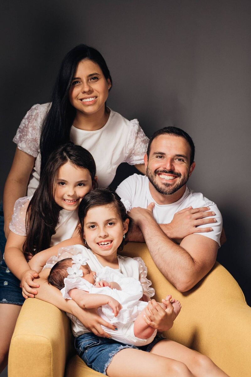 Luiza Bertunes Zaboto (age 8, sitting), with her mum Regiane and dad Leonardo, and sisters Helena (age 6) and baby Clara in July 2025.