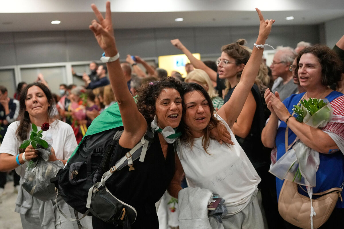Activists arrive at the Eleftherios Venizelos International Airport in Athens, Monday, Oct. 6, 2025 after being deported from Israel for taking part in a Gaza-bound aid flottila. (AP Photo/Petros Giannakouris)