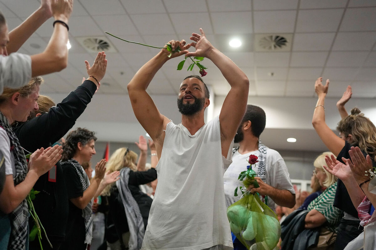 Activists arrive at the Eleftherios Venizelos International Airport in Athens, Monday, Oct. 6, 2025 after being deported from Israel for taking part in a Gaza-bound aid flottila. (AP Photo/Petros Giannakouris)