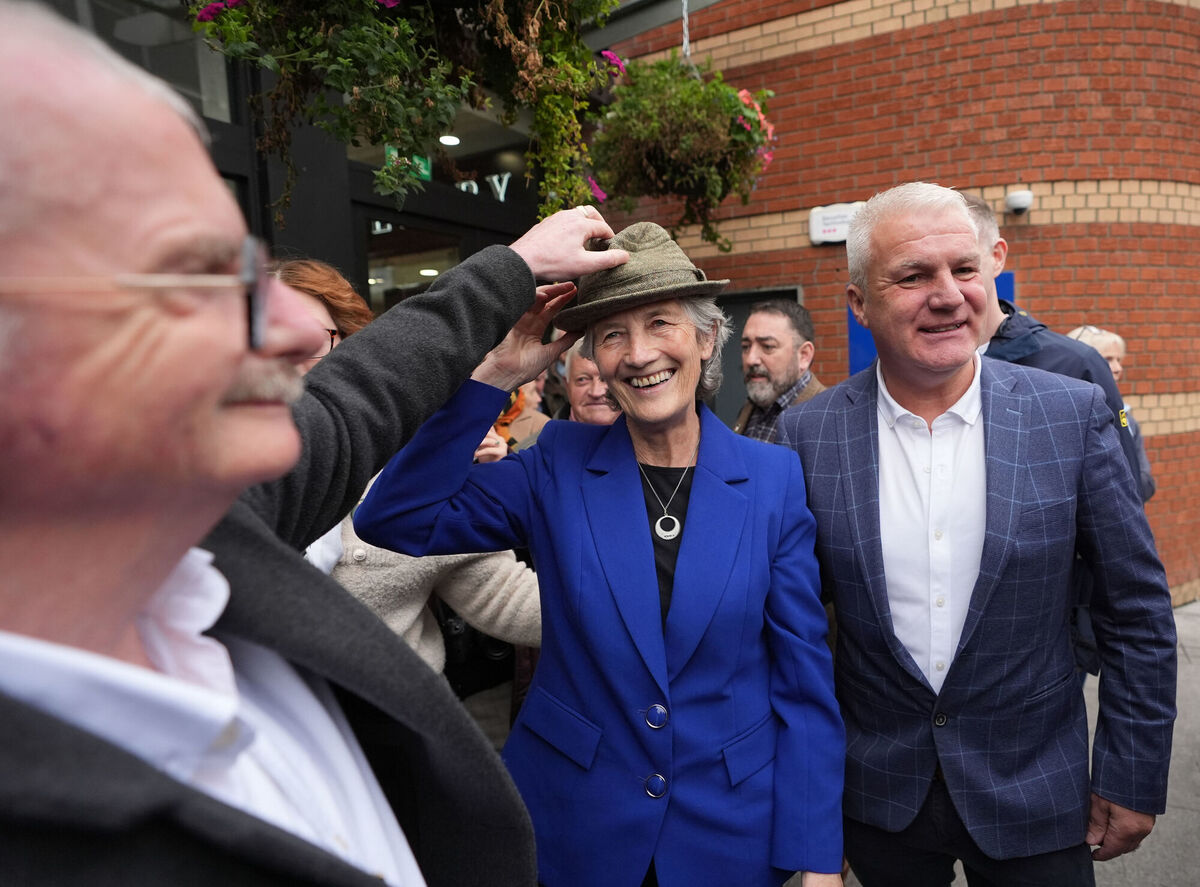 Independent candidate Catherine Connolly tries on a member of the public's hat as she meets shoppers and workers in the Navan Shopping Centre, Co Meath. Picture: Niall Carson/PA