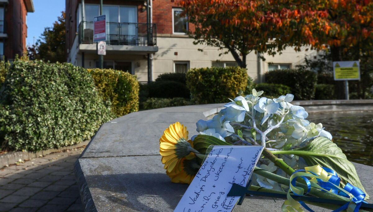 Flowers with a message and ribbons in the Ukrainian flag coulors on a fountain beside the apartment. Picture: Colin Keegan/ Collins, Dublin.