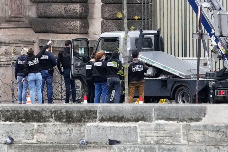 Police officers work by a basket lift used by thieves Sunday, Oct. 19, 2025 at the Louvre museum in Paris. (AP Photo/Thibault Camus)
