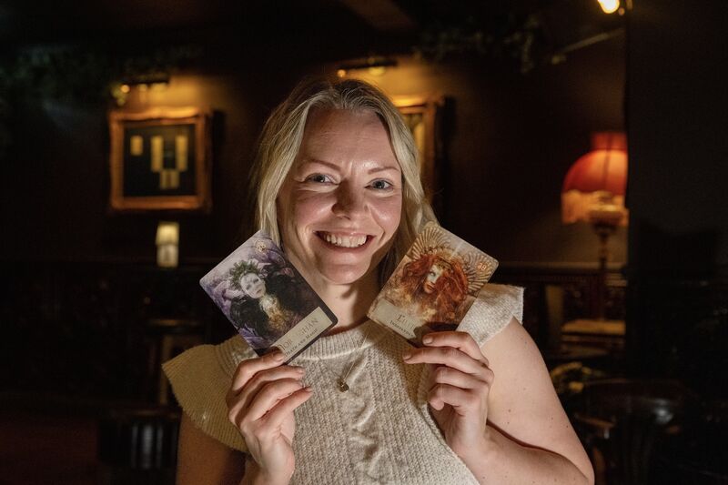 Emer Harrington holds two goddess cards from one of Stacey’s more unusual decks. Picture Chani Anderson