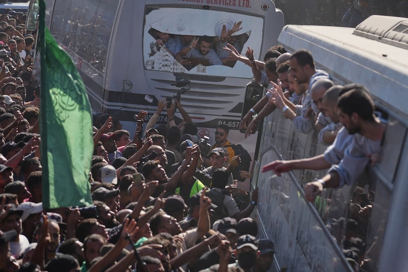 People gather to greet freed Palestinian prisoners arriving on buses in the Gaza Strip. Photograph: Jehad Alshrafi/AP