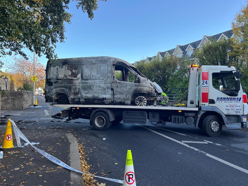 A burnt out Garda van is removed from the scene on Wednesday morning after  a major disturbance at Citywest Hotel on Tuesday night. Photograph: Sarah Burns