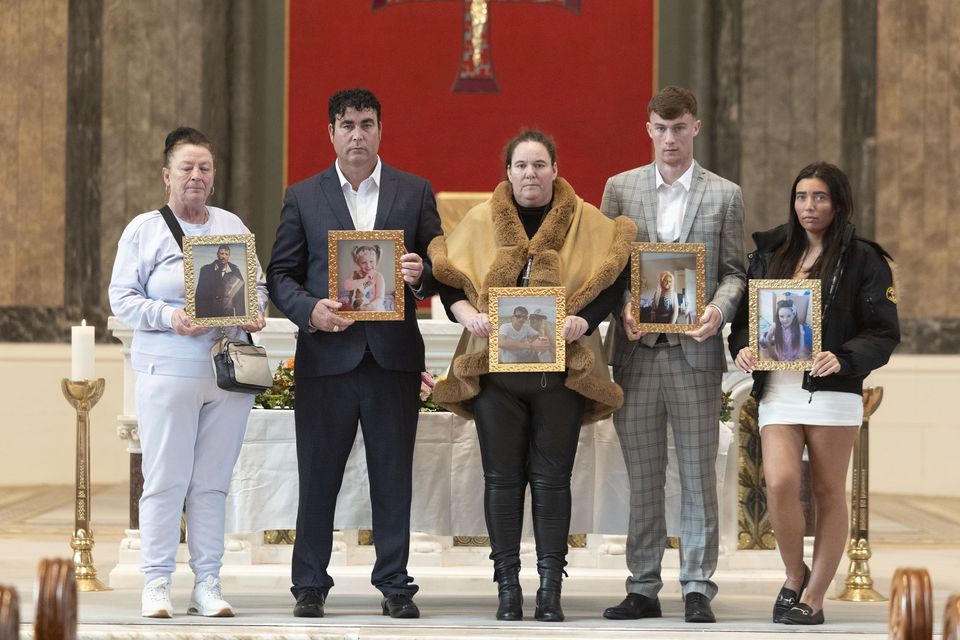 From left: Bridget Kelly, Ben Lynch, Ann Marie Cawley, Jonny Lynch and Tammie Lee Cawley hold photos of their loved ones at the 10-year anniversary mass. Photo: Collins
