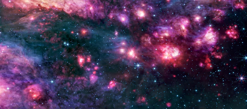 A pink, purple and splotchy picture of clouds in outer space