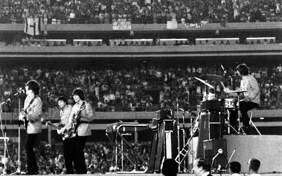 The Beatles performing at Shea Stadium, in 1965