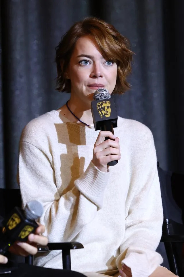 Getty Emma Stone wore a cozy ribbed white knit sweater that came over her hands